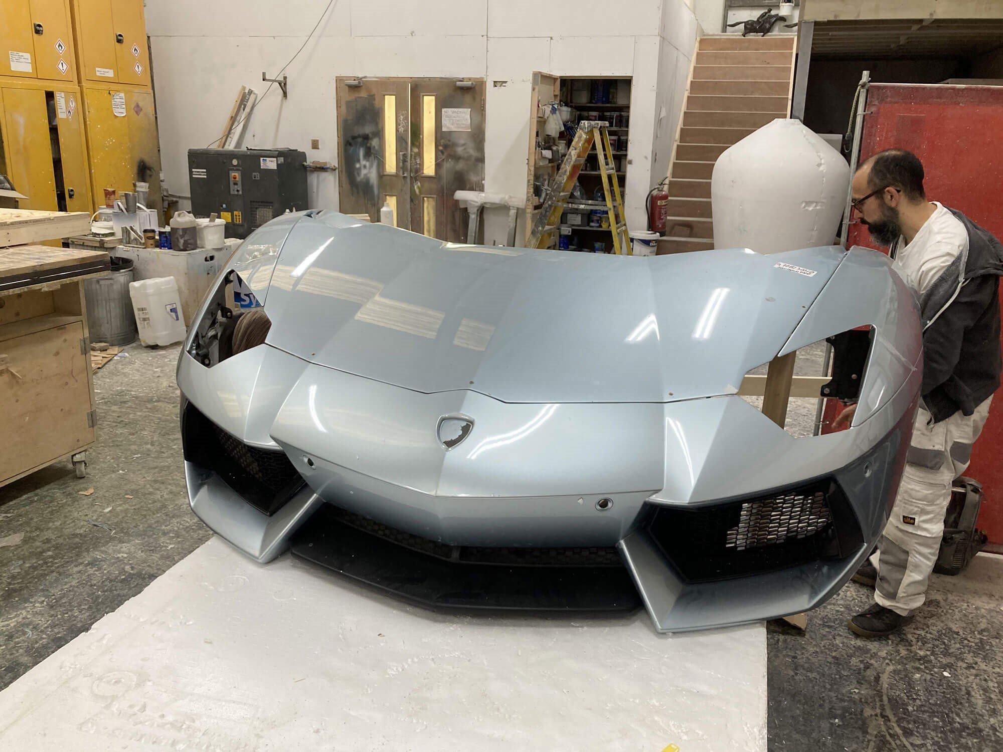 lamborghini prop crashing through a fake brick wall