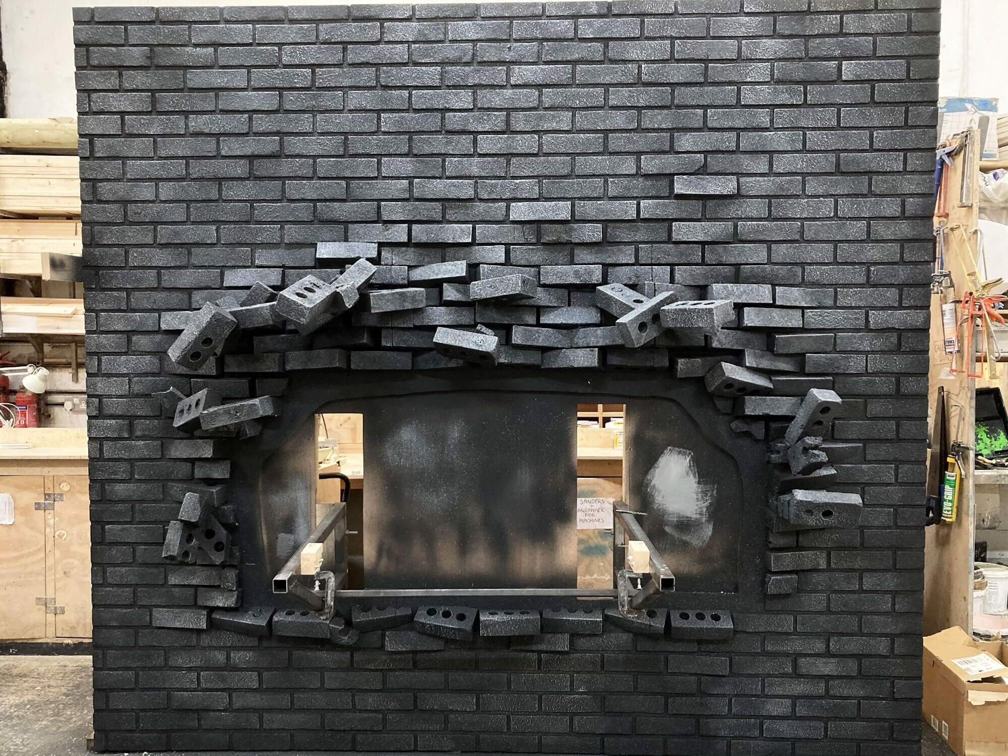 Prop made brick wall with exploding bricks.