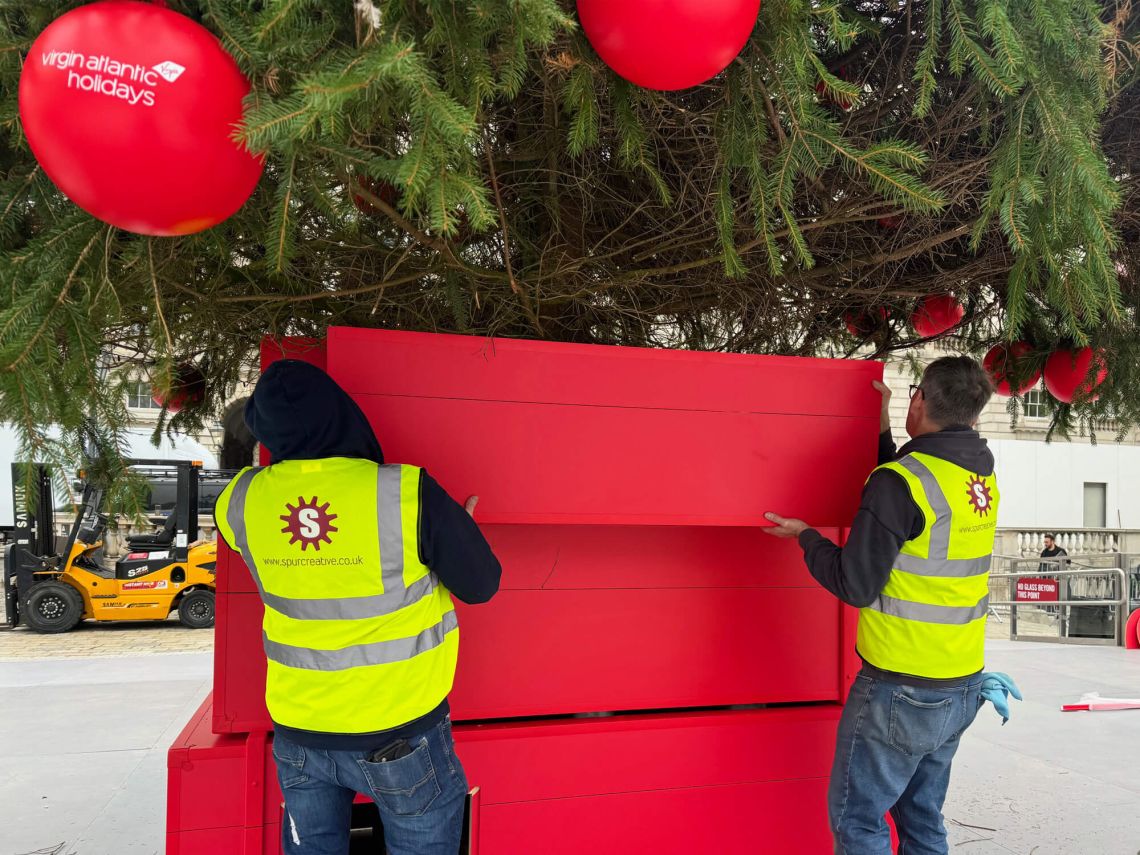 Lifting the Suitcases in place around the base of the tree.
