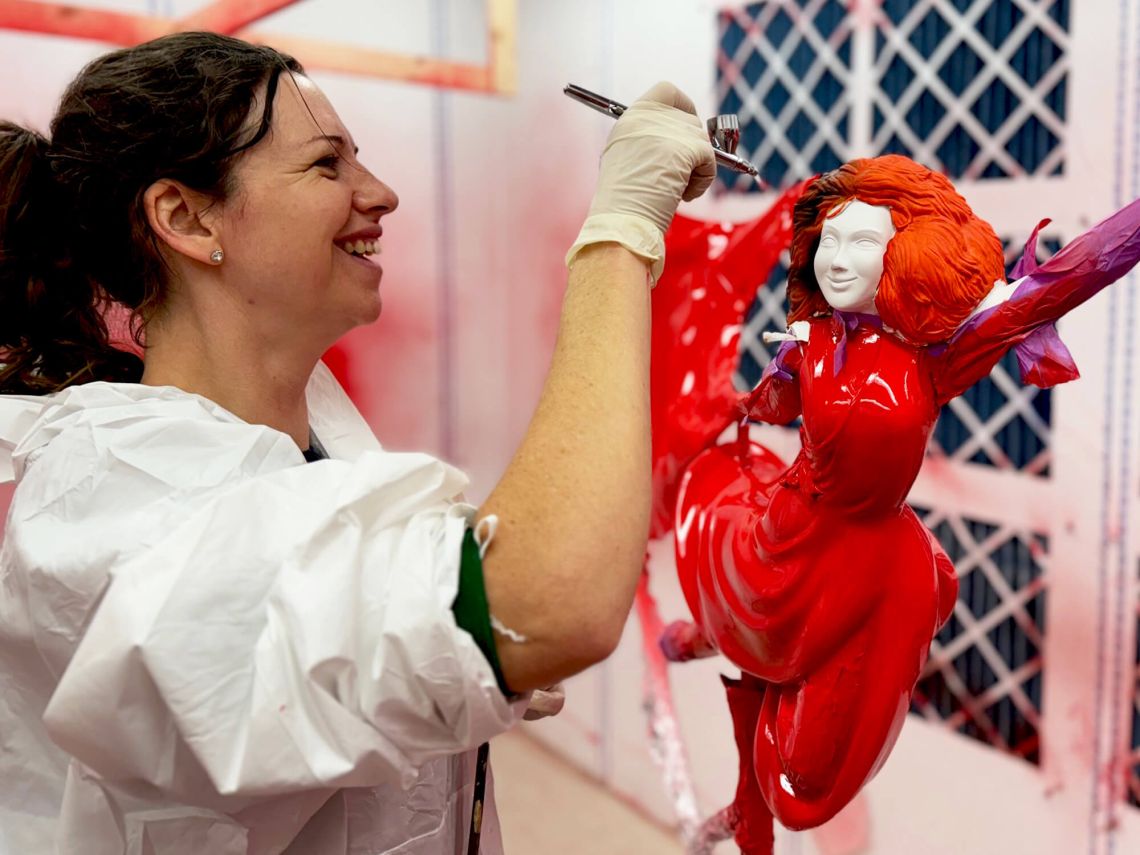 Airbrushing the face of the lady that tops the Christmas tree.