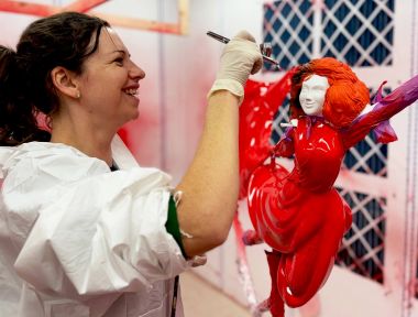 Airbrushing the face of the lady that tops the Christmas tree.